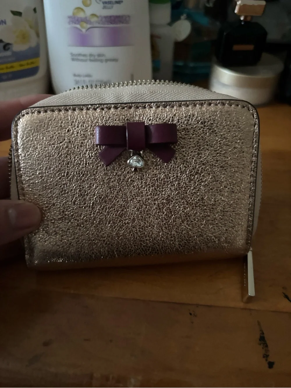 kate spade Rose Gold Metallic Zip Wallet with Purple Bow